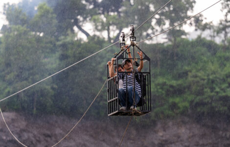 Trading food for medicine and crossing the river by zip line are part of life in Nepal flood zone